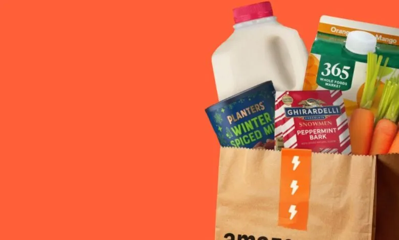 Grocery bag filled with milk, juice, snacks, and carrots.