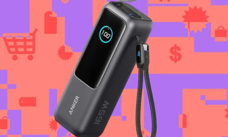 Anker 165W power bank with charging cable against a colorful shopping-themed background.