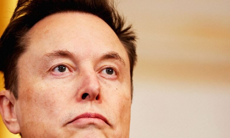 Close-up of Elon Musk looking upwards with a thoughtful expression.
