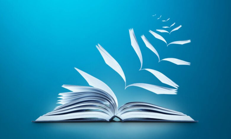 Open book with pages floating upwards on a blue background.
