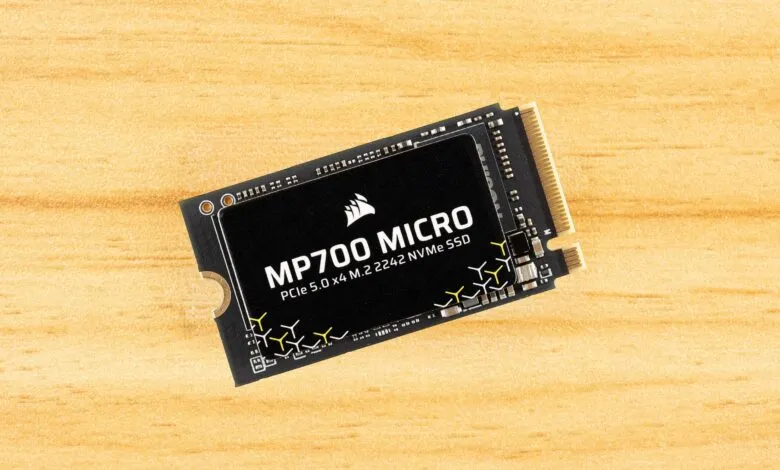 Corsair MP700 Micro NVMe SSD on wood surface.