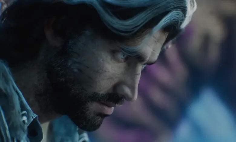 Close-up of a man with scars and intense blue eyes.