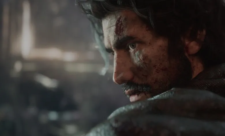 Close-up of a man with dark hair and a determined expression, showing signs of injury.