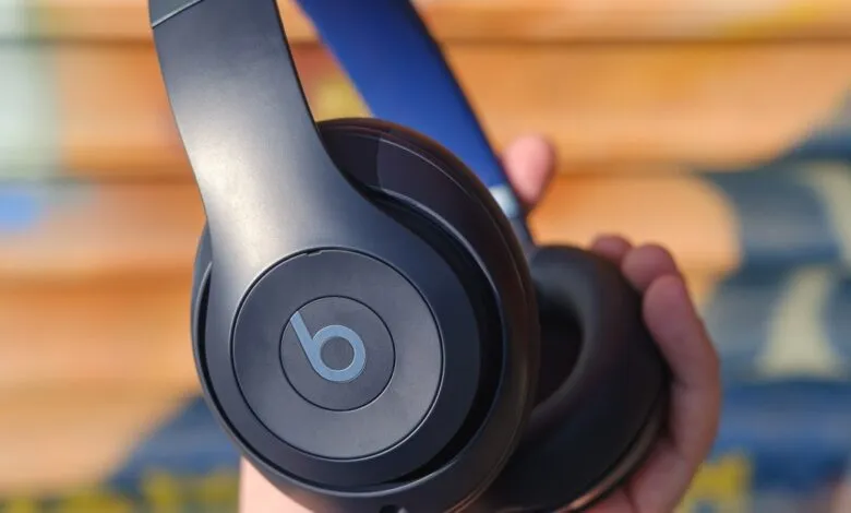 Close-up of black Beats headphones with blue accents.