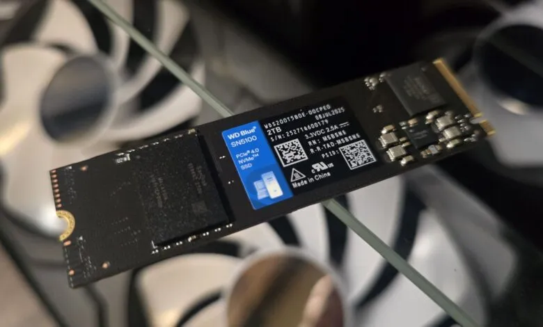 WD Blue SN5100 2TB NVMe SSD with components visible.