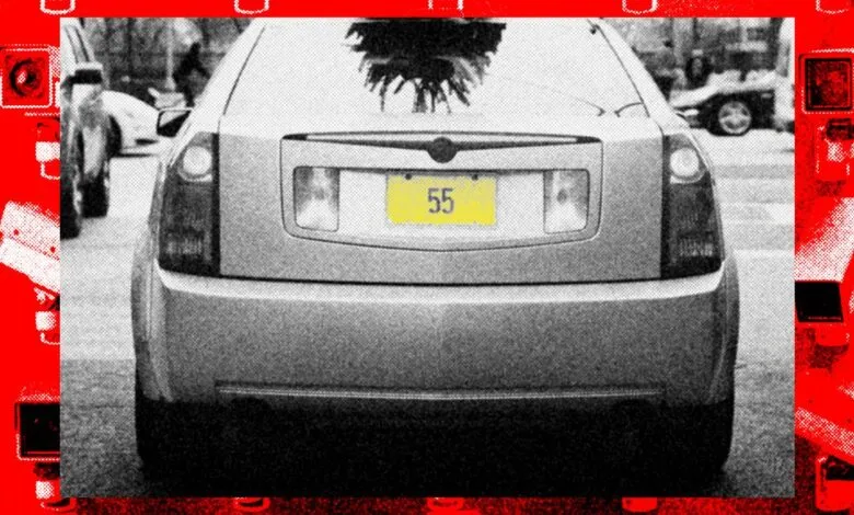 Rear view of car with license plate '55' surrounded by security cameras.