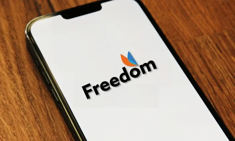 Smartphone displaying the Freedom Mobile logo on a white screen.