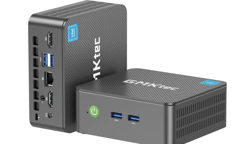 Two gray GMKtec mini PCs, one standing, one lying down.