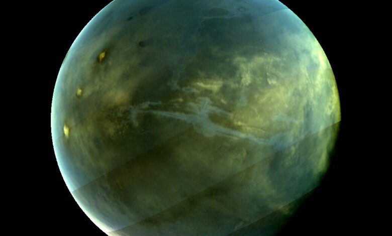 Image of Titan, Saturn's largest moon, showing its hazy atmosphere and surface features.