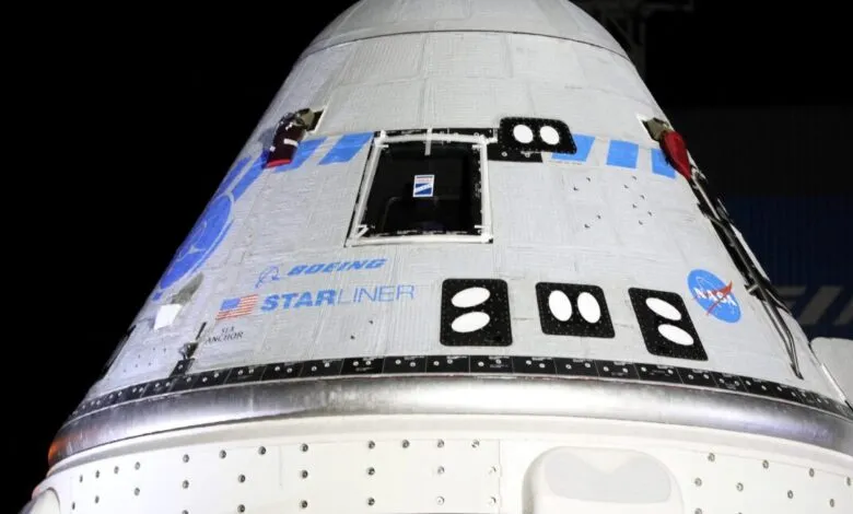 Close-up of the Boeing Starliner spacecraft with NASA and Boeing logos.