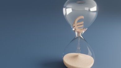 Hourglass with Euro symbol sand, time running out for finances.