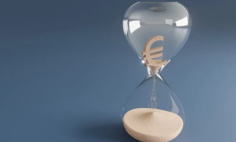 Hourglass with Euro symbol sand, time running out for finances.