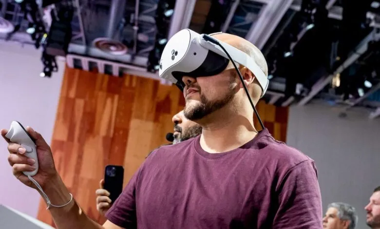 Man wearing white VR headset holding controller, immersed in virtual reality.