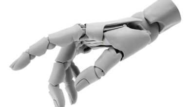 Articulated gray robot hand with visible joints against a white background.