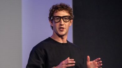 Mark Zuckerberg speaking with hands gesturing, wearing glasses.