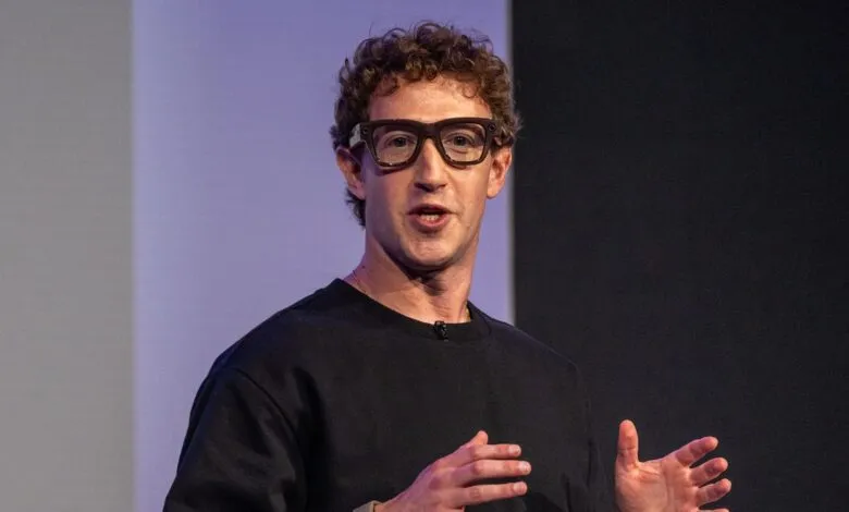 Mark Zuckerberg speaking with hands gesturing, wearing glasses.