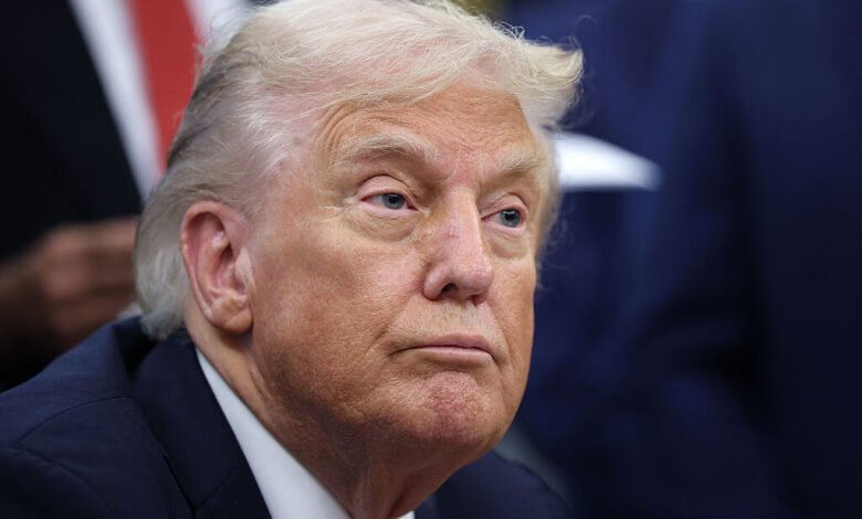 Close-up of Donald Trump in a dark suit, looking off-camera.