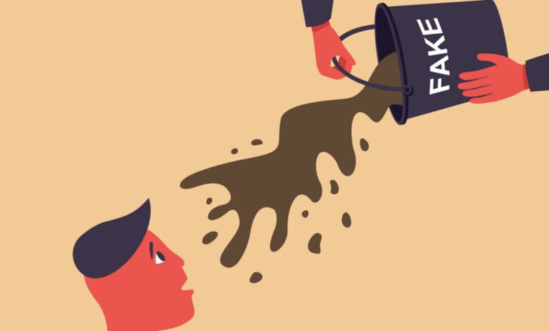 Bucket labeled 'FAKE' pours dark liquid onto a person's head.