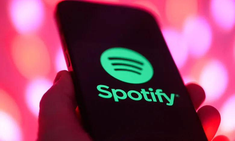 Spotify logo displayed on a smartphone screen, held in hand.