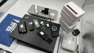 Collection of electronic devices including routers, phones, and a signal detector.