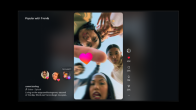 Social media reel of group of friends looking down at camera with heart overlay.
