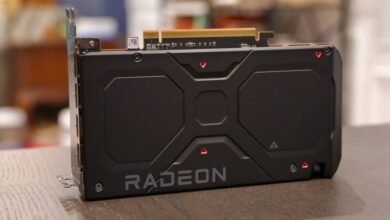 Close-up of a black AMD Radeon graphics card on a wooden surface.