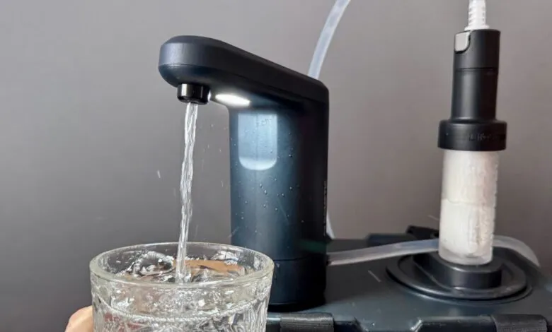 Water flowing from a LifeStraw dispenser into a glass.