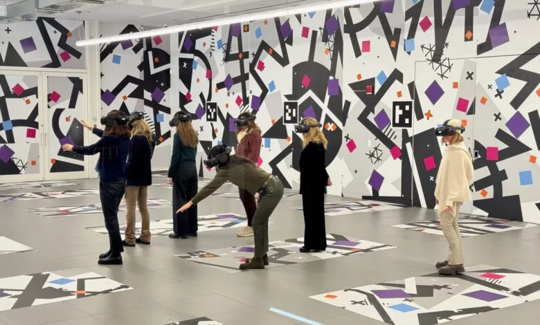 Group of people wearing VR headsets in a modern, colorful room.