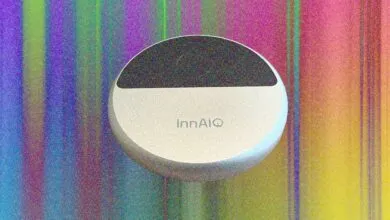 InnAIO device with black top and white bottom against colorful striped background.