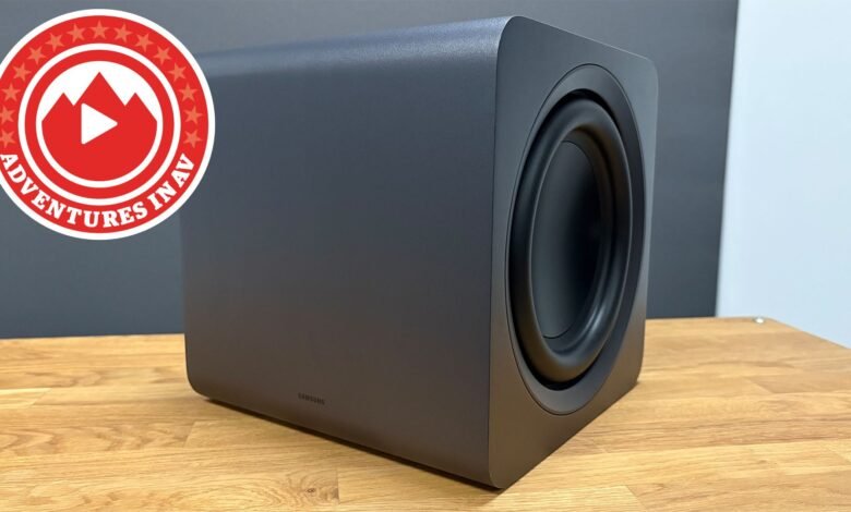 Samsung subwoofer on wood surface with Adventures in AV logo.