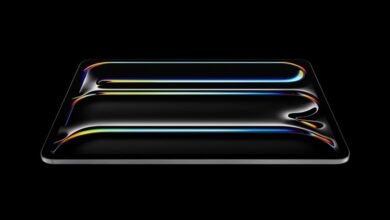 Sleek, black tablet with iridescent light reflections on a dark background.