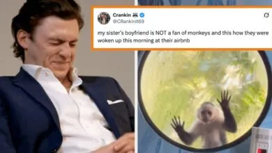 Man grimaces next to a monkey peering through a window, humorous contrast.