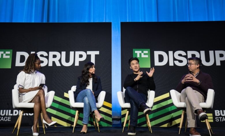 Four panelists sit on stage at TC Disrupt conference, discussing technology.