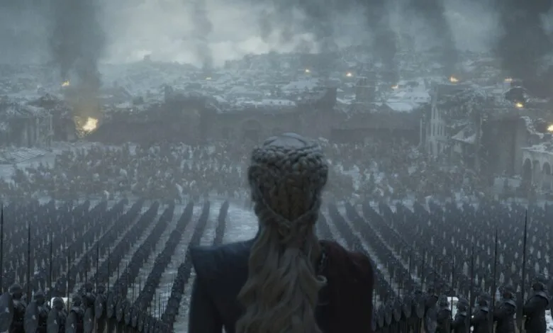 Daenerys Targaryen surveys her army amidst a destroyed city.