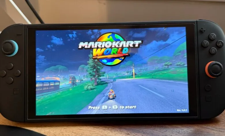 Nintendo Switch OLED displaying the Mario Kart World game on its screen.