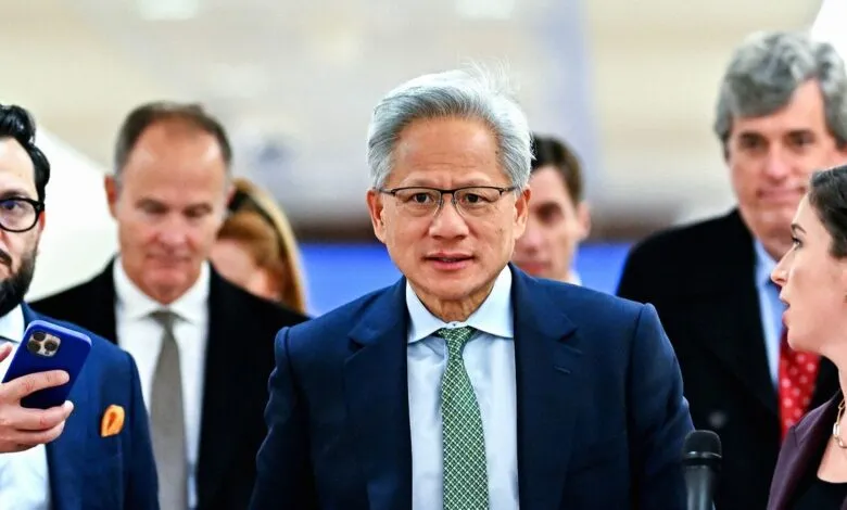 Jensen Huang, CEO of Nvidia, surrounded by people.