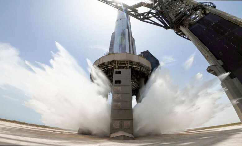 Rocket launchpad undergoing water deluge test, water spraying from all sides.