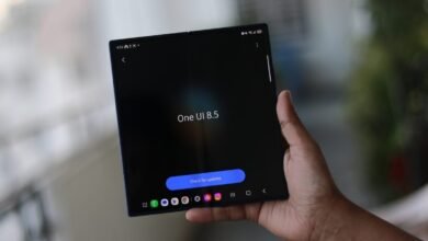 Hand holding a Samsung Galaxy Z Fold with One UI 8.5 on screen.