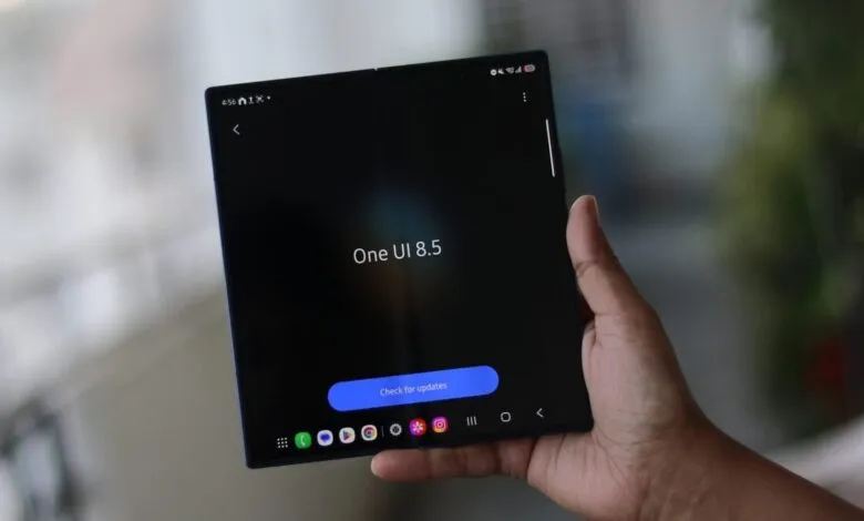 Hand holding a Samsung Galaxy Z Fold with One UI 8.5 on screen.