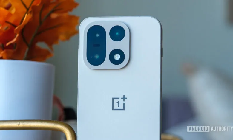 Close-up of a white OnePlus phone showing its camera array.