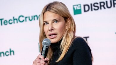 Denise Dresser speaks at TechCrunch Disrupt conference, holding a microphone.