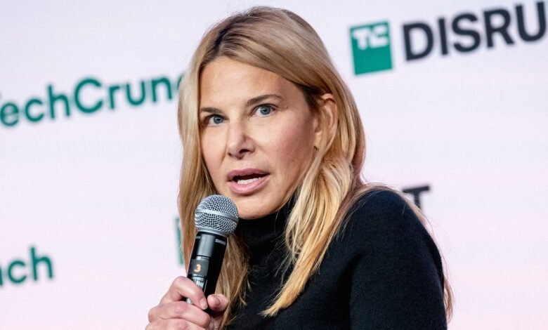 Denise Dresser speaks at TechCrunch Disrupt conference, holding a microphone.