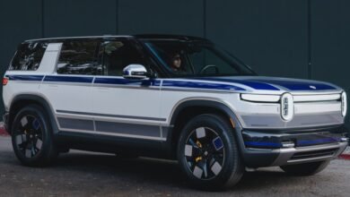 Rivian R1S electric SUV with custom blue and gray stripes.