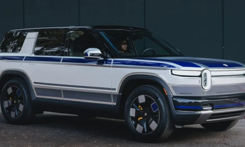 Rivian R1S electric SUV with custom blue and gray stripes.