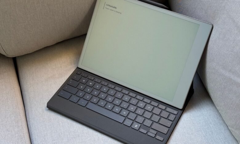 Remarkable 2 tablet with Type Folio keyboard case resting on a gray couch.