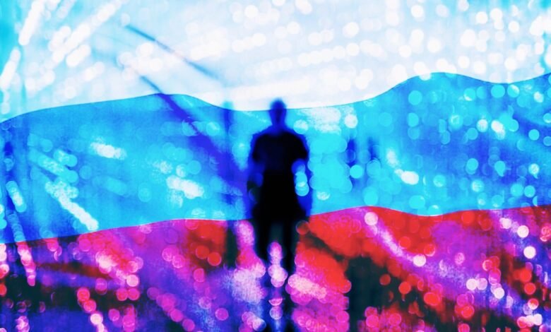 Silhouette stands against a blurred Russian flag backdrop with bokeh lights.