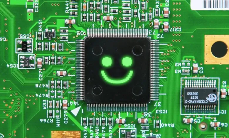 Close-up of a green circuit board with a smiley face on a chip.