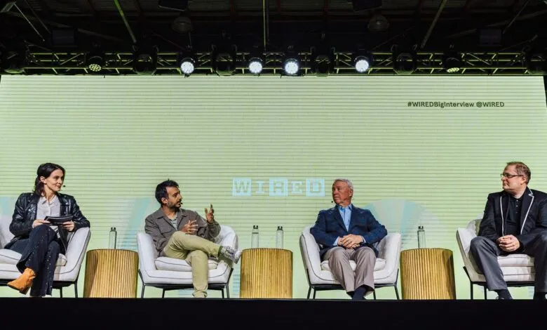 Four people sit on stage at a Wired event, engaging in a panel discussion.