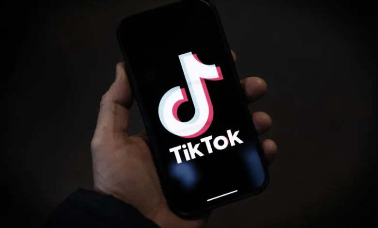 Close-up of a smartphone displaying the TikTok logo on its screen.