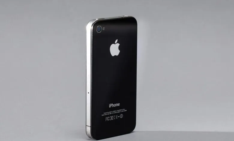 Back view of a black iPhone 4 with silver trim and Apple logo.